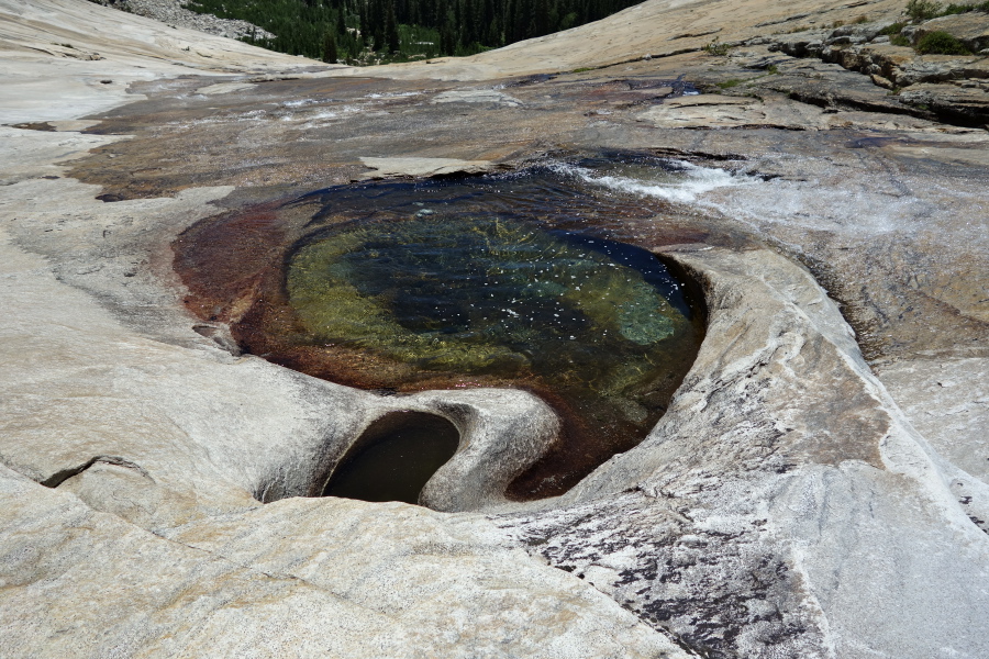 A whirl of water part-way down the slide.