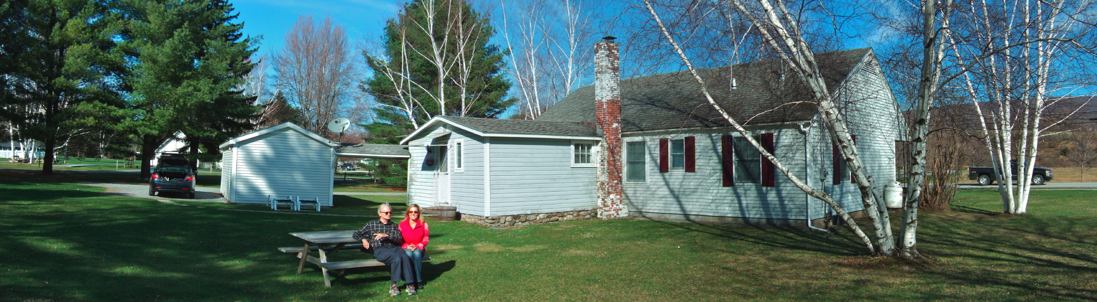 David and Laura enjoy the sun behind The Birches cottage.