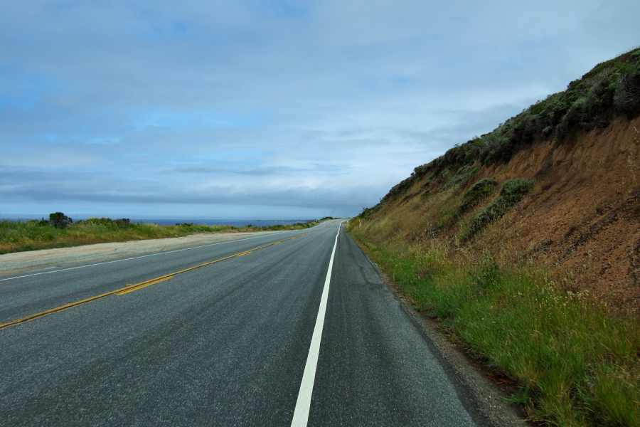 Riding north on a nearly empty CA1 under cloudy but clearing skies.