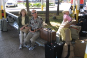 Kay and David wait to pick up the rental car.