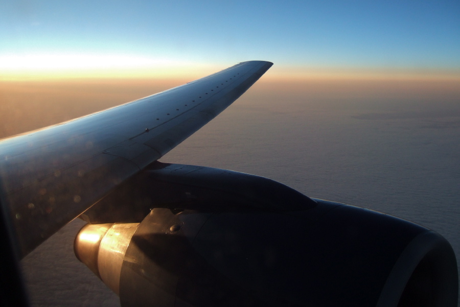 Looking back toward the setting sun over a dreary overcast somewhere over Ontario
