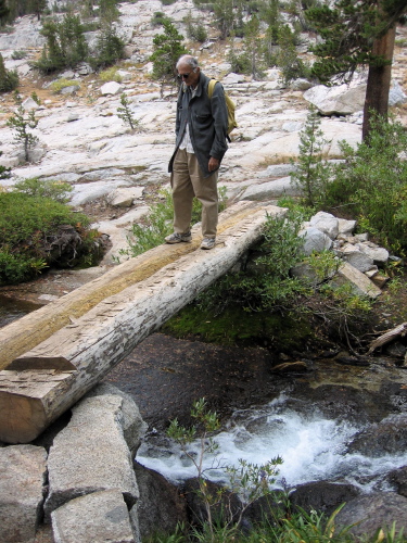 David crosses a rushing Treasure Creek.