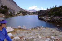 Alice walks past an unnamed lake.