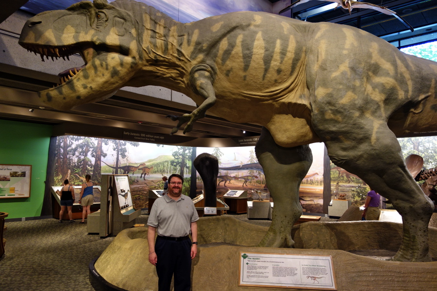 Len stand before the T-rex.