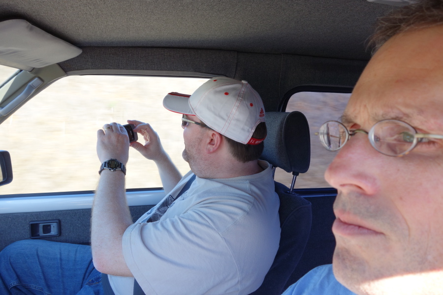 Len takes a photo out the window.