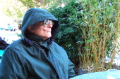 David keeps warm while sitting outside.