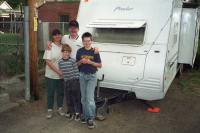 Lisa, Danny, Dan, and Matthew in their back yard next to the Prowler.