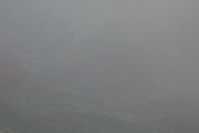A helicopter can be glimpsed flying below the clouds.
