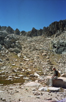 David rests on a pink granite rock at the head of the canyon.