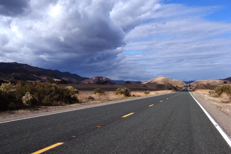 An angry cloud rises over Fremont Peak and Cienega Rd.